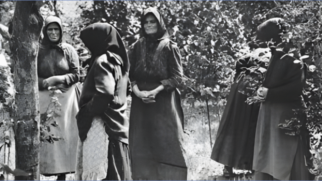 Historic black-and-white photograph of rural Hungarian women standing together outdoors in the early 20th century, reflecting everyday village life during the era of the Angel Makers of Nagyrév.